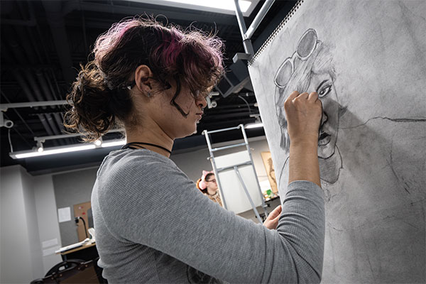 UWGB art student in a drawing class