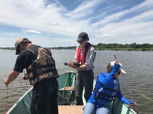 Students working on a boat in the wetland. Photo by Amy Corrazzino-Lyon.