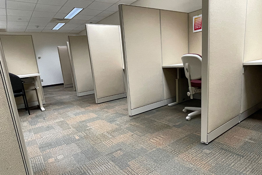 UWGB Testing center is a carpeted space with office chairs and desks with cubicle partitions