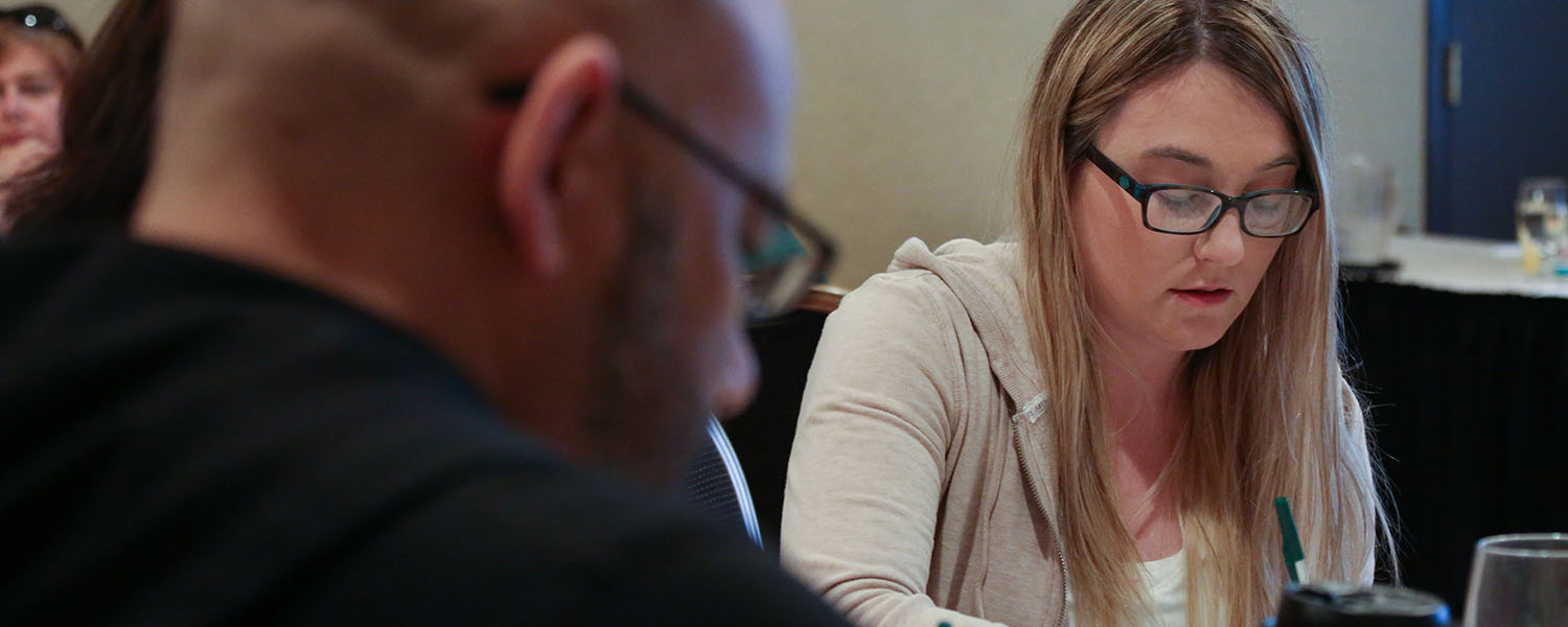 woman taking notes during training session