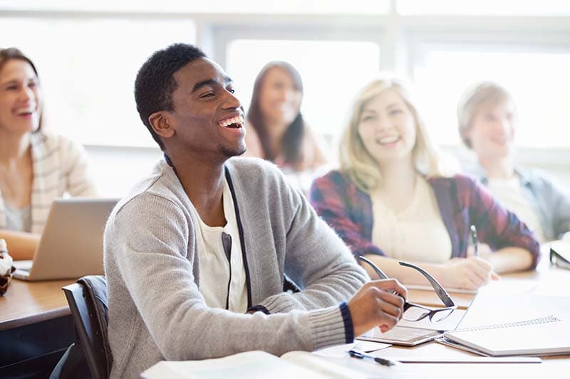 man smiling during class interaction
