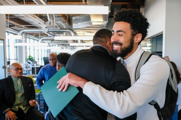Two people hugging at business pitch competition at Titletown Tech