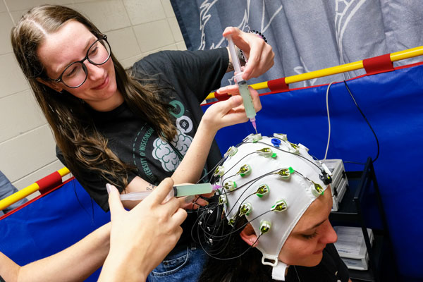 Psychology student performing EEG research on volunteer