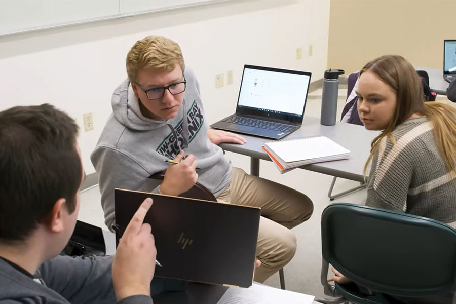 Three students working in a group during class