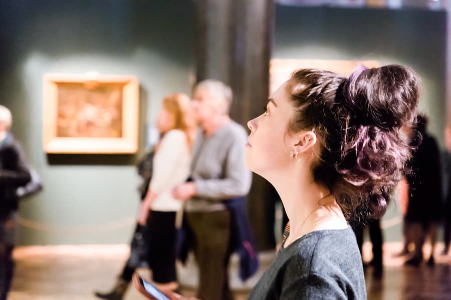 Student admires art work in art museum