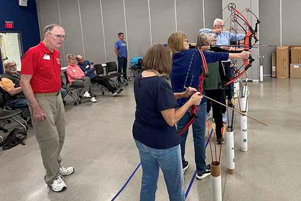 Instructor with an adult archery class
