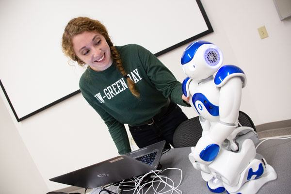 Female engineering student works on robot