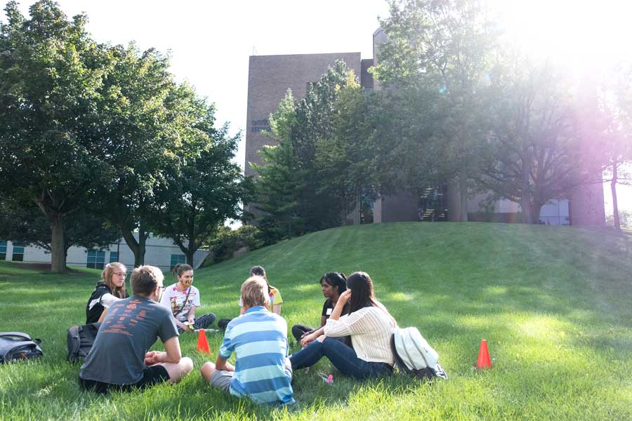 Group of students sitting outside on the UWGB Campus