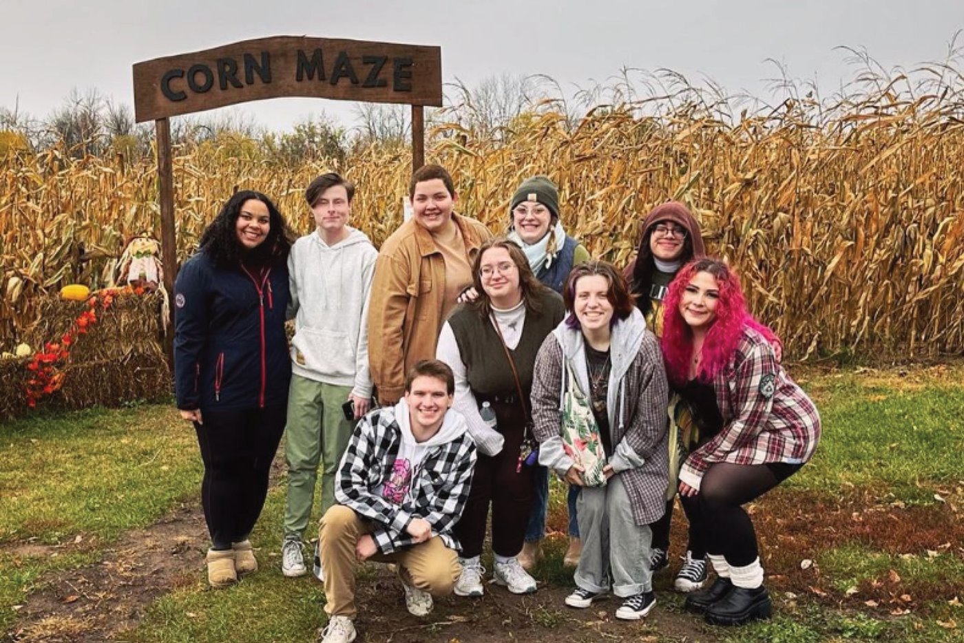 Theta Eta Alpha, a gender-inclusive sorority, poses in front of a corn maze at a social outing