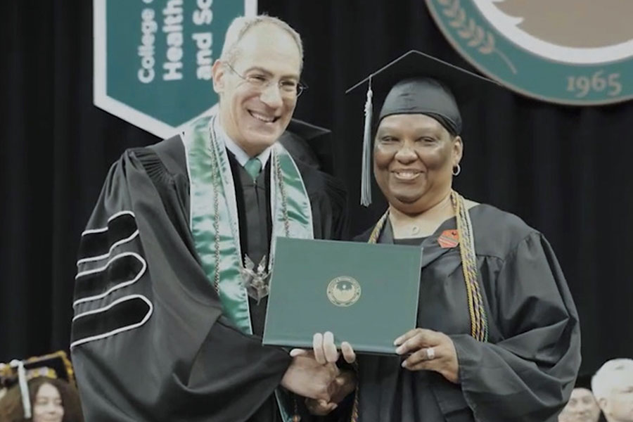 Ingrid Parker-Hill with the Chancellor at graduation.