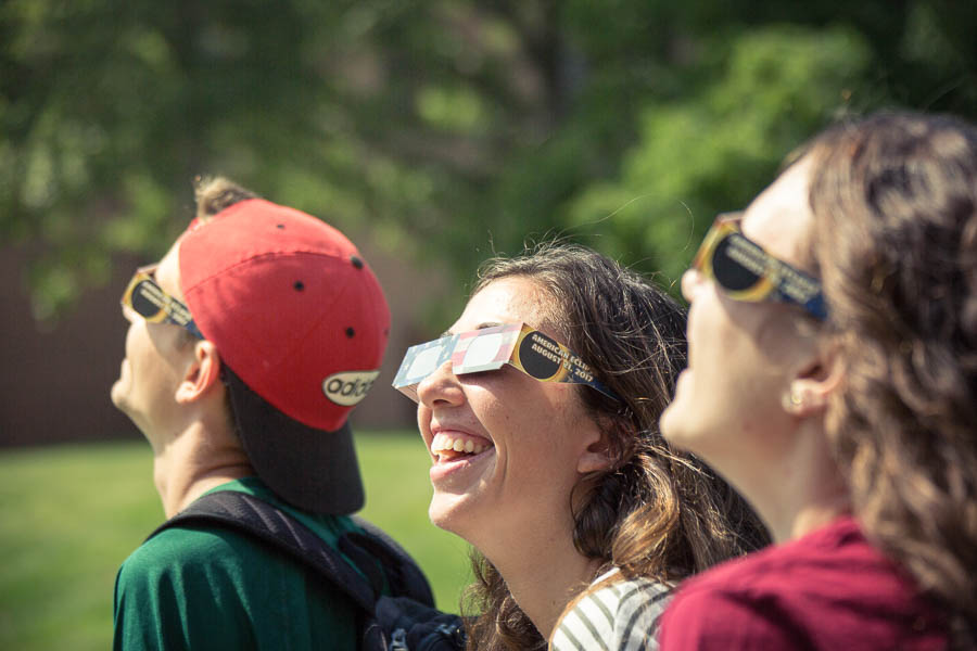 students with eclipse glasses having fun