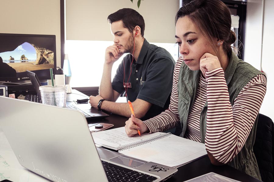 UW-Green Bay students study with their laptops at a table in the union