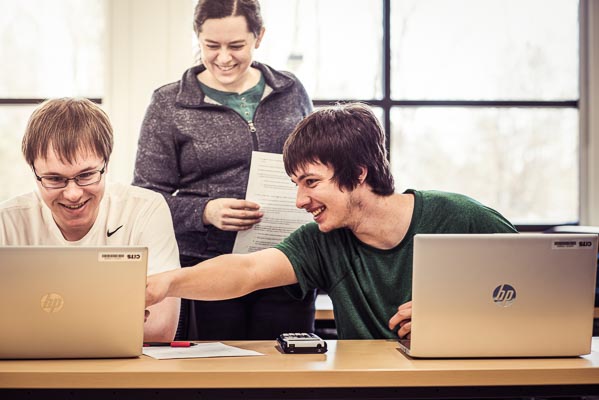 Students and professors working on computers