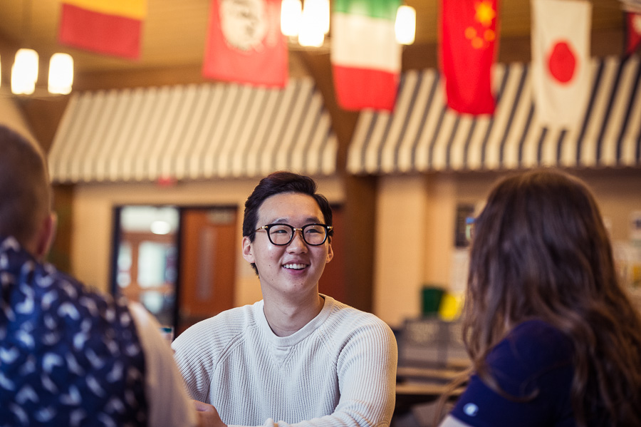 International student visiting with friends in the Marinette campus café