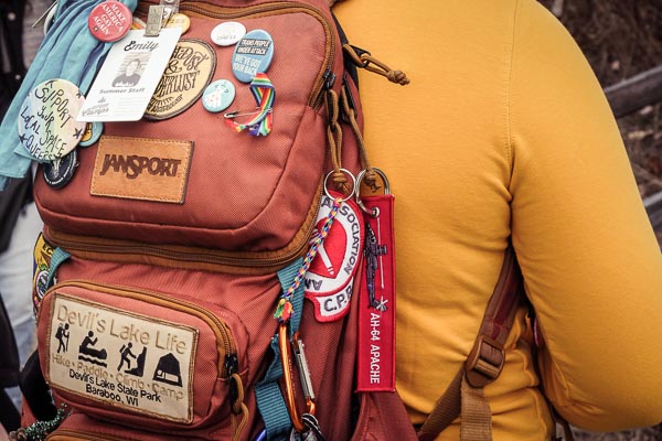 Student's backpack with assortment of badgees and pins