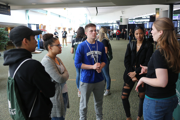 Prospective students talking to admissions staff.