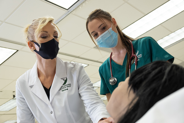 Student and teacher working in the Nursing Simulation lab