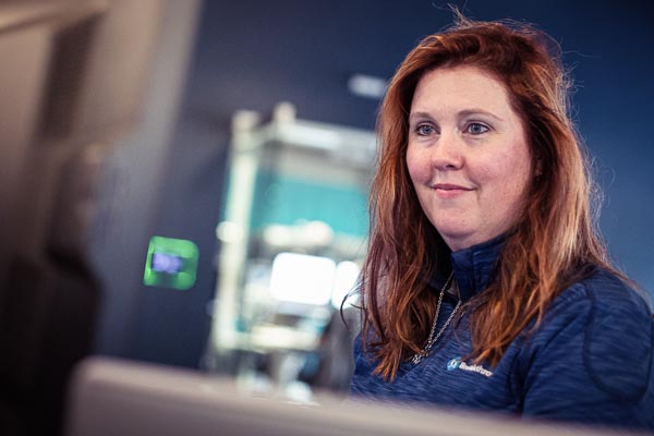 Students sits at the computer during her internship.