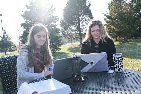 Two students studying at a picnic table