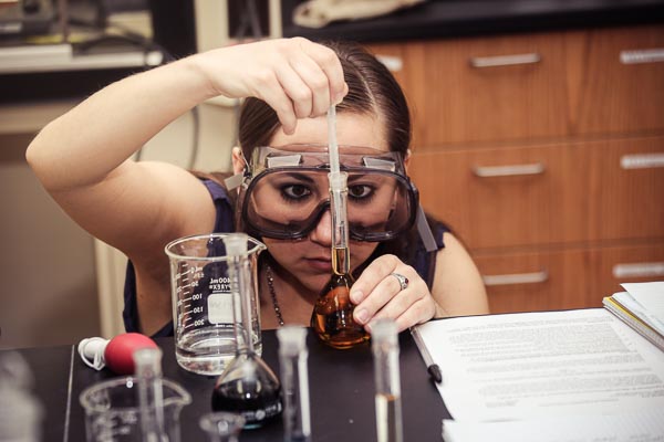 A female UW-Green Bay student filling a test tube.