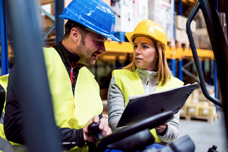 two people in hard hats working