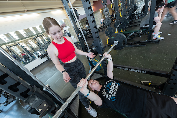 Two students work out in the Kress Events Center.