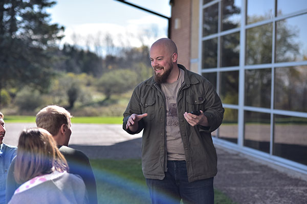 Faculty lecturing outdoors with students