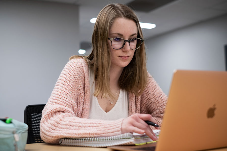 Female student studies at lap top