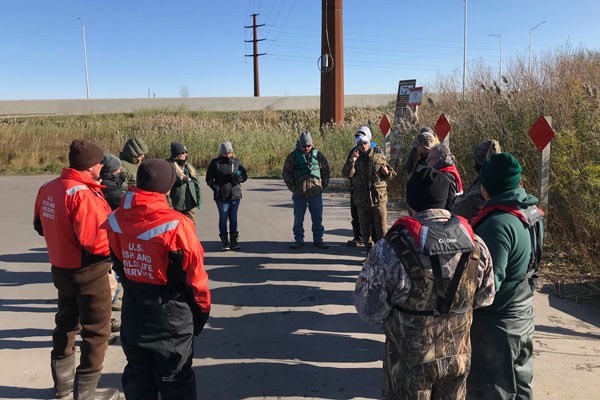 Group of students meet outdoors to work on environmental conservation