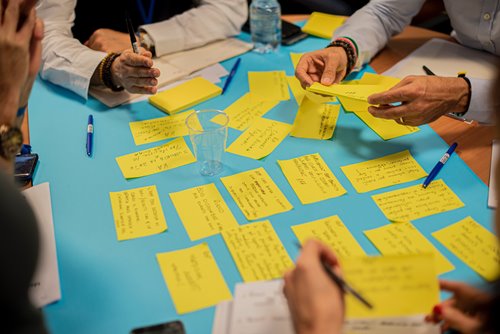 people gathered around a table with notecards