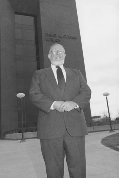 David A. Cofrin standing in front of the David A. Cofrin Library