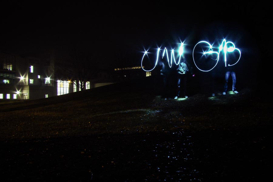 UWGB written in light at night in the quad