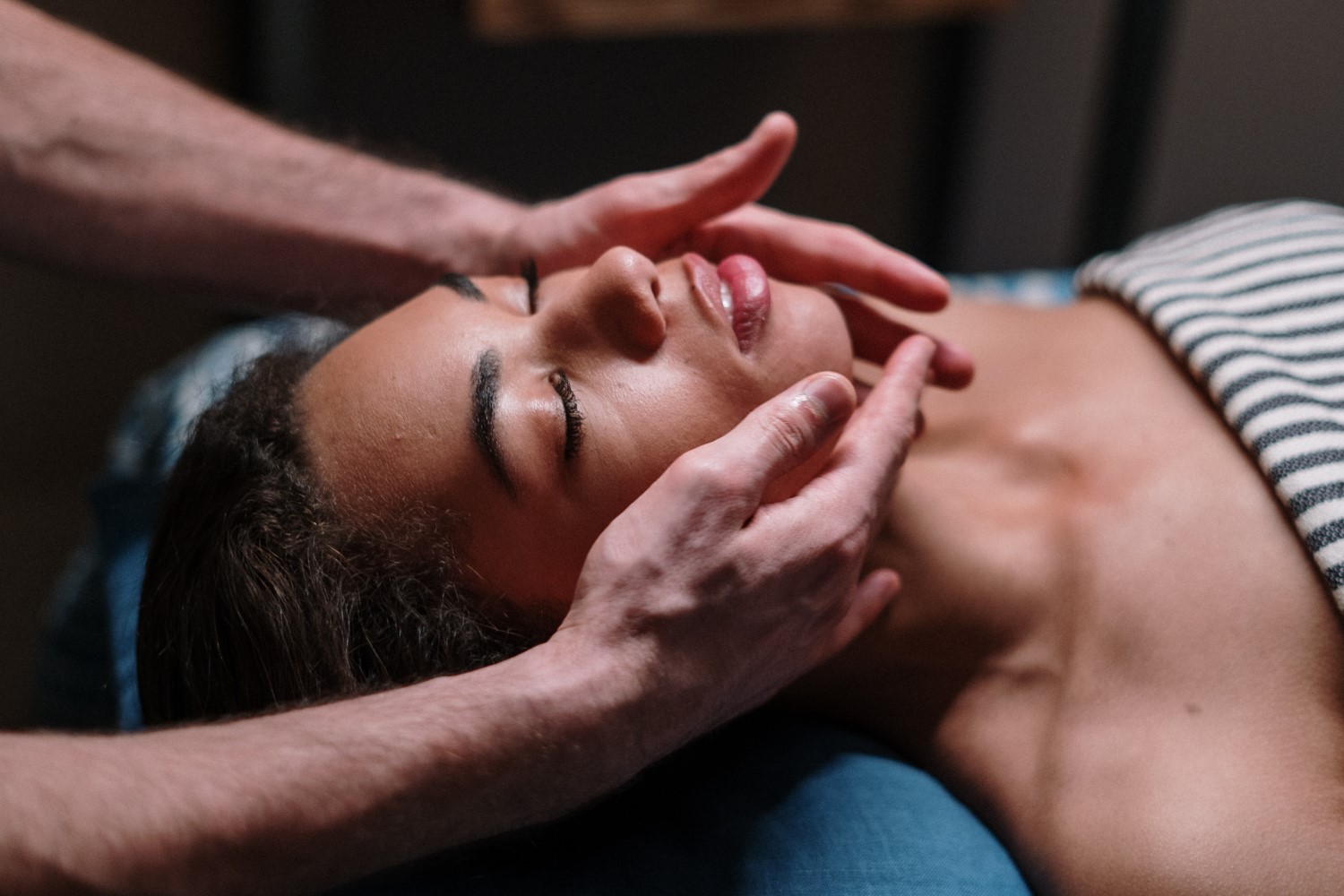 Close-up image of a woman getting a face massage