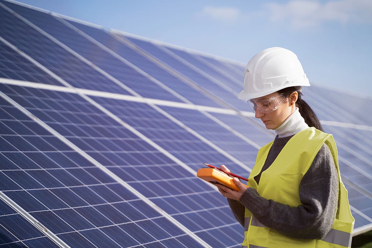 Engineer by solar panel