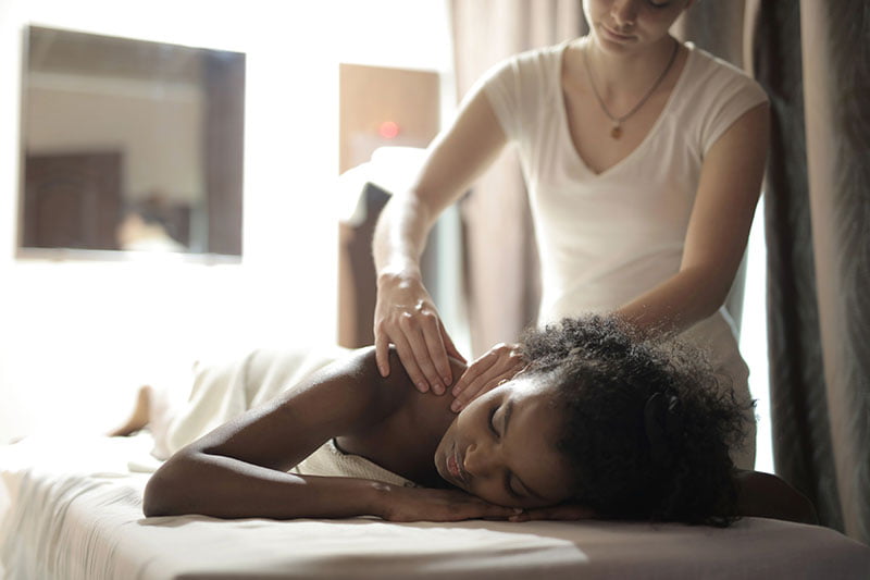 Massage therapist with client