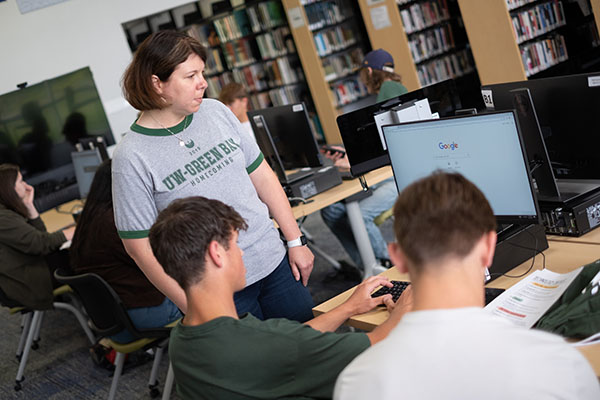 advisor working with two students