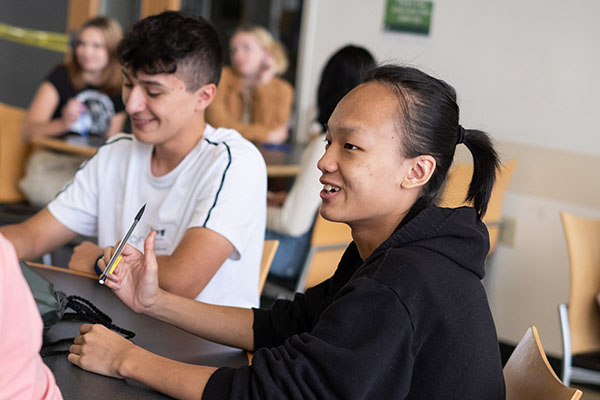 group of students sitting at a table together