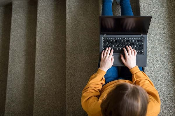 view from above of teenager using laptop