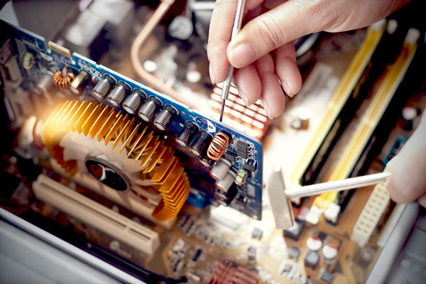 Close up of someone working on circuit board