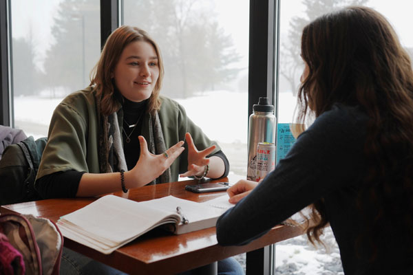 Student meets with mentor in UW-Green Bay's Common Grounds coffee shop