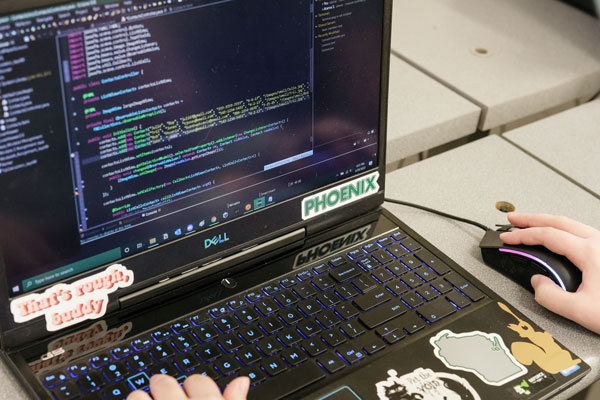 Close up of student working on computer programming