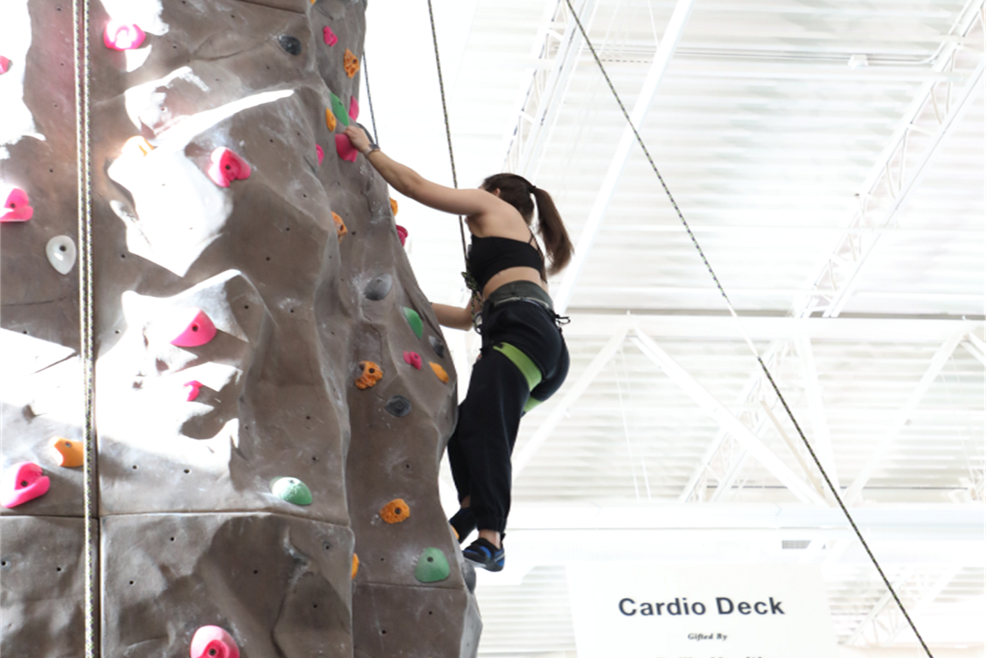 Student climbing a rock wall
