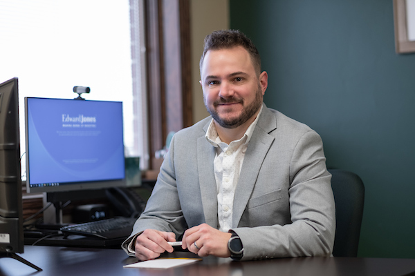 Eric Friedland, who earned his master's degree from UW-Green Bay, sits at his desk.