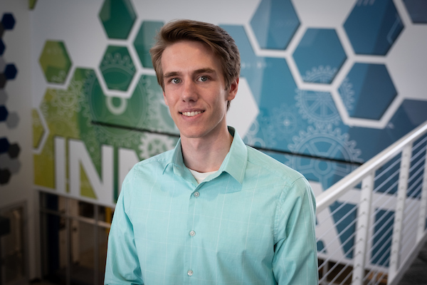 Jordan Cioni, Spring 2022 Commencement speaker, smiles and poses in the STEM Innovation Center.