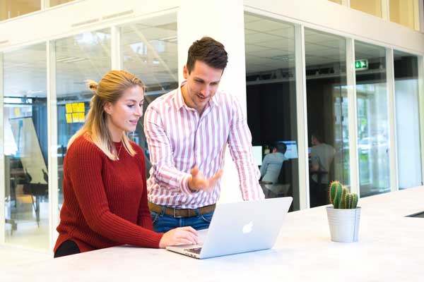 Students work together at computer