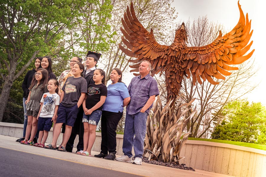 Family at phoenix statue with graduate