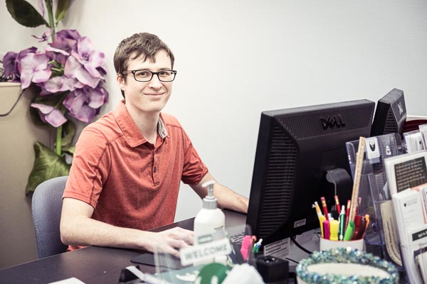 student employee working on a computer