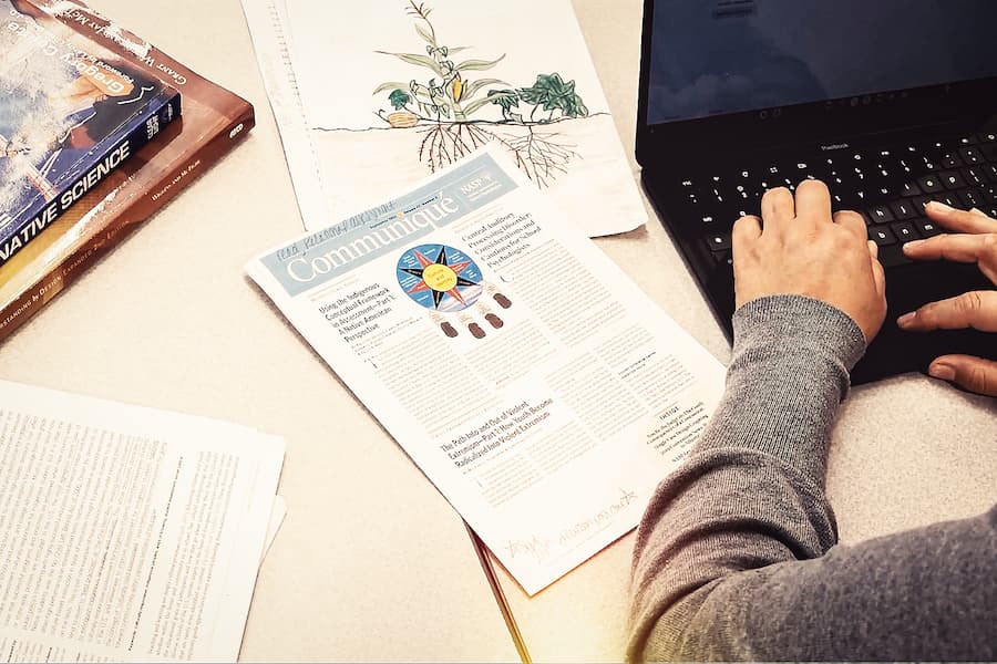 Close up of student studying on laptop at desk