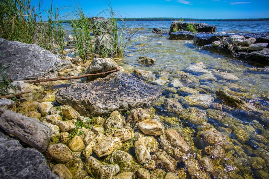 Close up of water running over over rocks in the lake