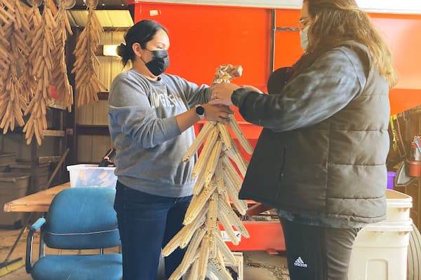 Indigenous students assemble corn